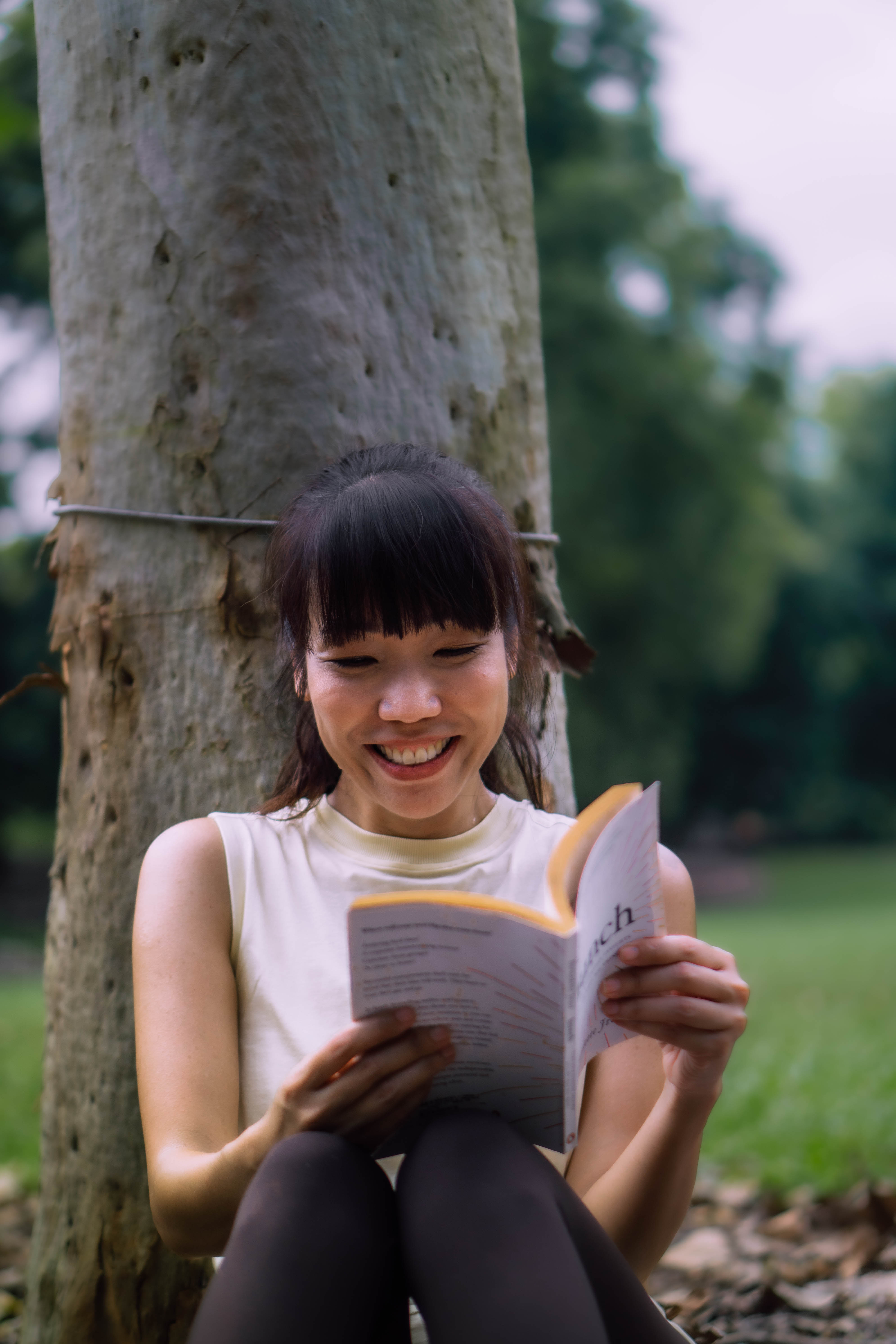Hazel reading quietly by a tree on a Saturday evening